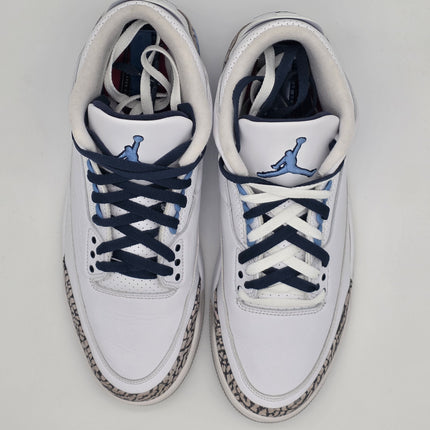 White sneakers with blue accents on a light gray background