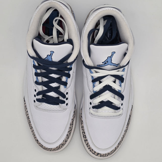 White sneakers with blue accents on a light gray background