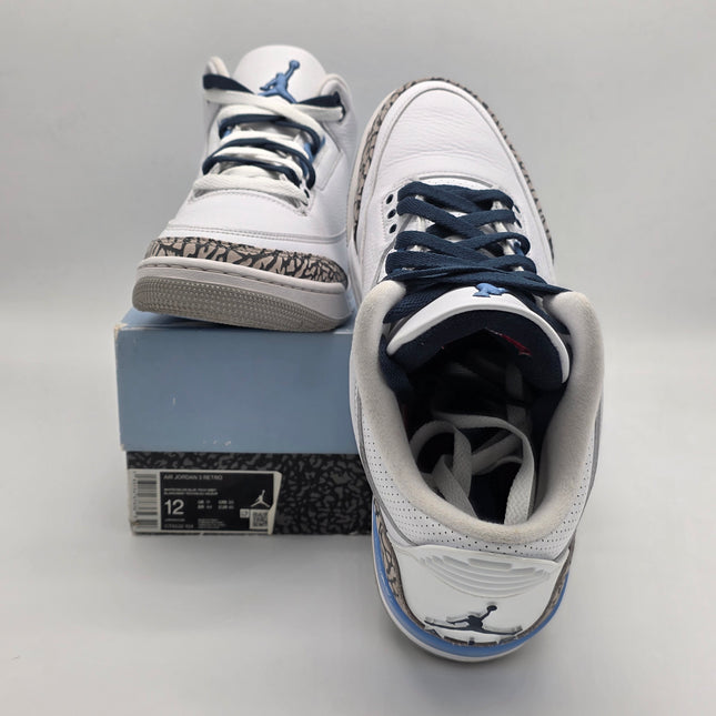 White high-top sneakers with blue laces on a gray surface