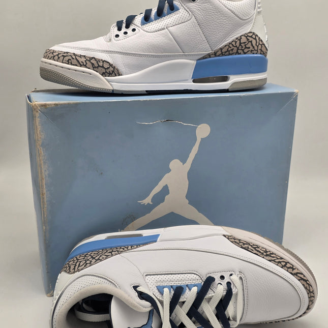 White sneakers with blue and gray accents on a Jordan brand box.